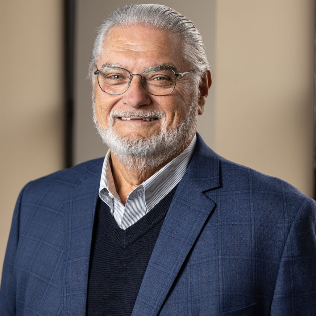 corporate headshot of older man